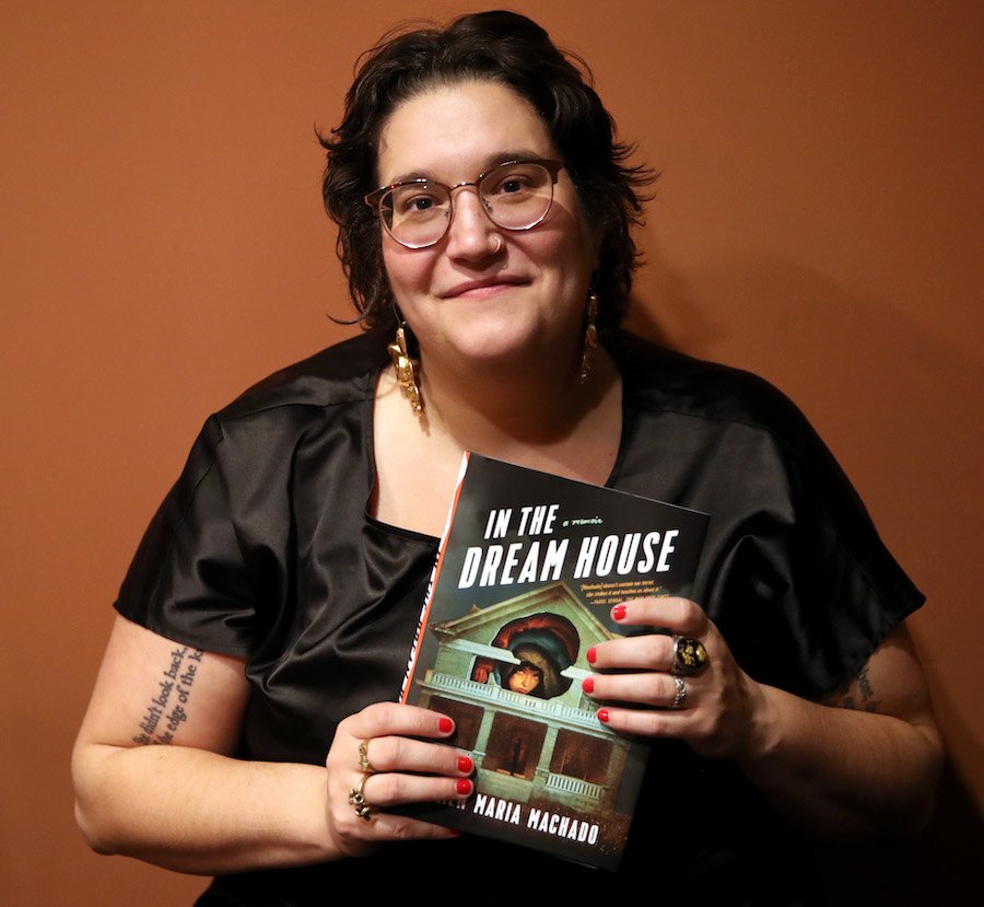 Author Carmen Maria Machado holding a copy of her book 'In the Dream House'