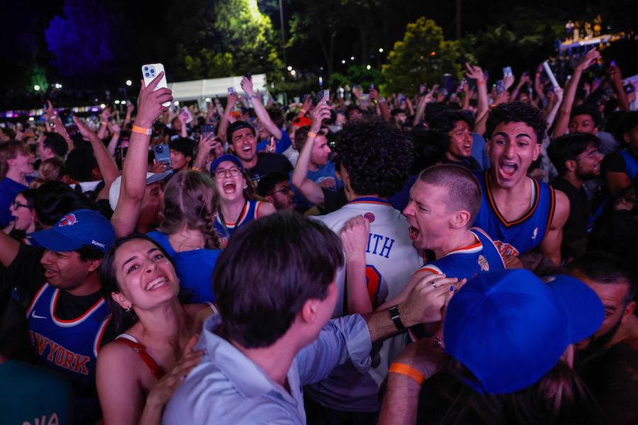 Fans celebrate the New York Knicks winning the 2026 NBA championship on the streets of New York City.