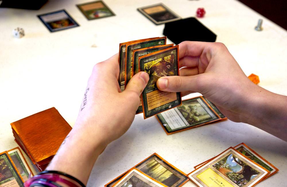 A 'Magic: The Gathering' fan holds cards from the game