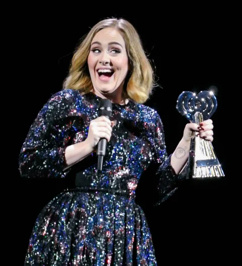 Adele accidentally kisses fan onstage