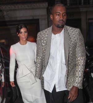 Kanye West and Kim Kardashian heckled after late fashion arrival