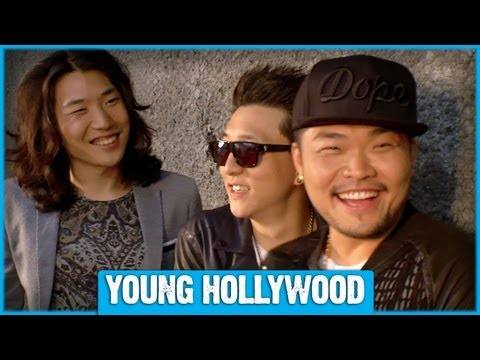 Aziatix members playful at an interview, sitting on stools in a studio