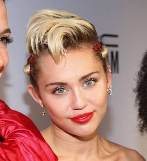 Miley Cyrus poses topless with rumored model girlfriend