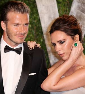 David and Victoria Beckham smooch at basketball game