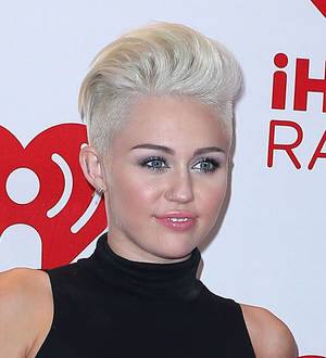 Miley Cyrus cavorts with topless stripper during raunchy routine