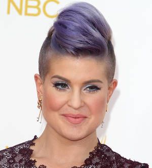 Kelly Osbourne holds back Joan Rivers jacket