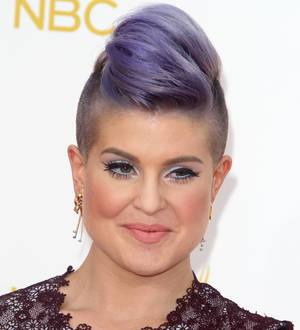 Kelly Osbourne holds back Joan Rivers jacket
