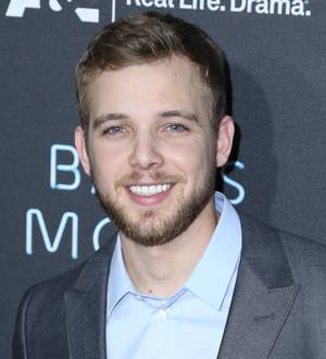 Max Thieriot and wife Lexi Murphy smile brightly on their wedding day in a close-up photo