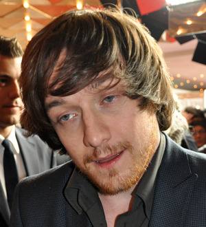 James McAvoy in a light-colored suit and dark tie, looking slightly to the side
