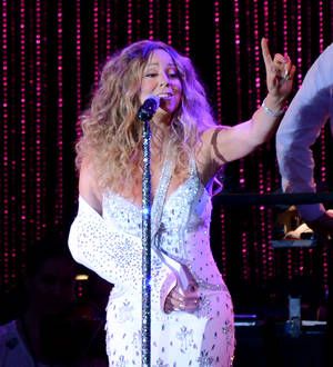 Injured Mariah Carey performs at Sandy benefit show