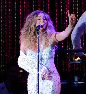 Injured Mariah Carey performs at Sandy benefit show