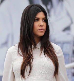 Pregnant Kourtney Kardashian strips for DuJour magazine