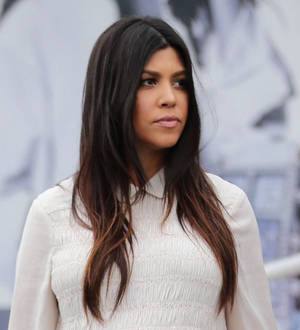 Pregnant Kourtney Kardashian strips for DuJour magazine