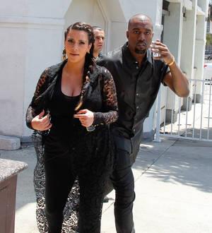 Kanye West hits head on street sign
