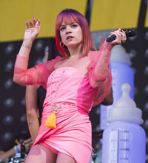 Lily Allen pays tribute to husband during bizarre 'baby bottles' Glastonbury show