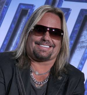 Vince Neil takes stage tumble
