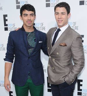 Joe and Nick Jonas reunite at Christmas gig