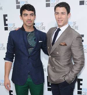 Joe and Nick Jonas reunite at Christmas gig