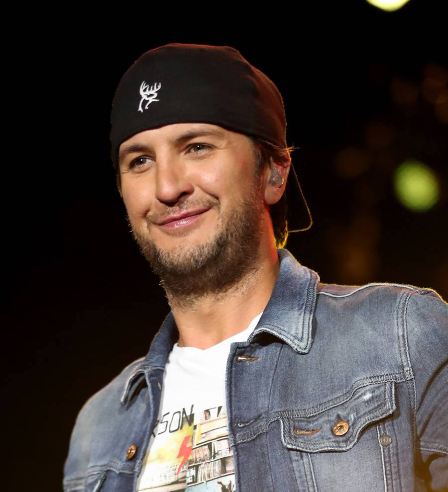 Luke Bryan performs with his arm in a sling after bike accident