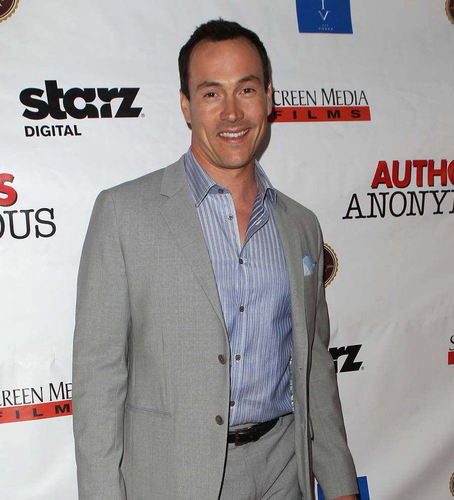 Chris Klein and his wife, wearing white, pose with their newborn baby
