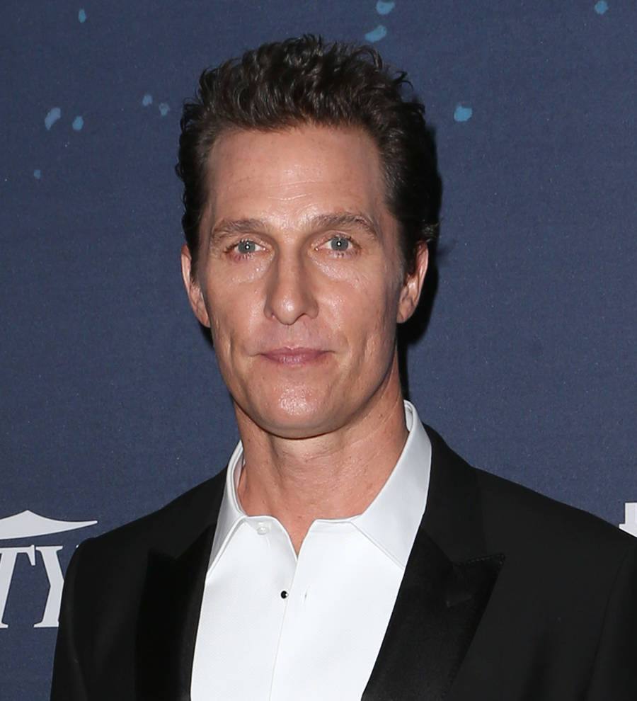 Matthew McConaughey with a microphone on a stage, speaking at an event or conference