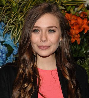 Elizabeth Olsen and Bryan Cranston circling Godzilla