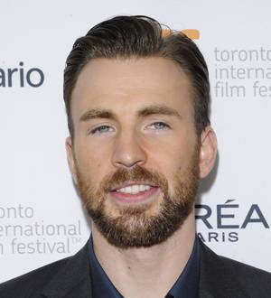 Chris Evans and Minka Kelly walk a dog on a sidewalk during their rekindled romance