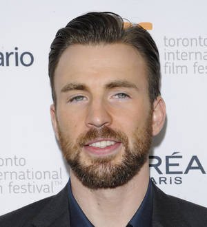 Chris Evans and Minka Kelly walk a dog on a sidewalk during their rekindled romance
