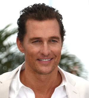 Matthew McConaughey on the Cannes red carpet, posing in a black suit and bow tie
