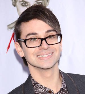 Christian Siriano proposes to Kyle Smith on a boat, holding a ring box and bending one knee