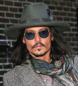 Johnny Depp surprises fans at The Lone Ranger screening