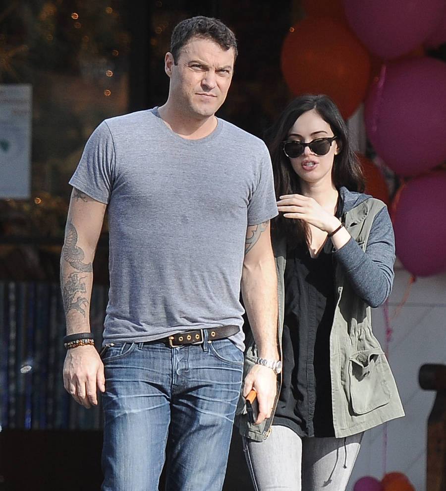 Megan Fox and Brian Austin Green walk in Milan. Fox wears a striped top and Green wears a white t-shirt