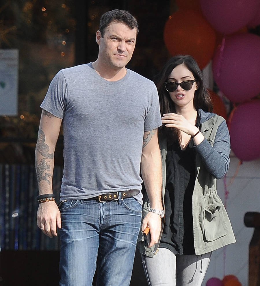 Megan Fox and Brian Austin Green walk in Milan. Fox wears a striped top and Green wears a white t-shirt