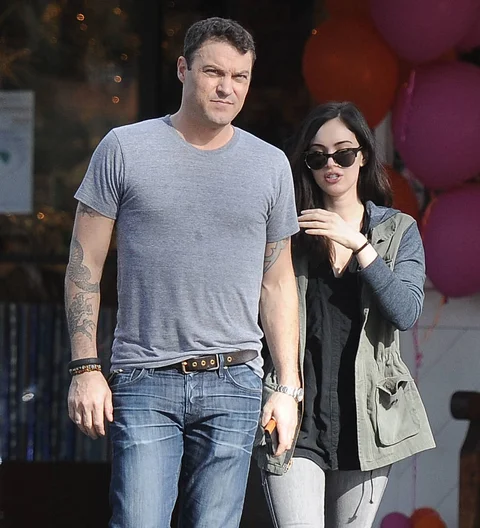 Megan Fox and Brian Austin Green walk in Milan. Fox wears a striped top and Green wears a white t-shirt