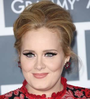 Adele receives MBE from Prince Charles