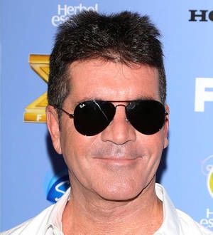 Simon Cowell cuddles up to two new pets