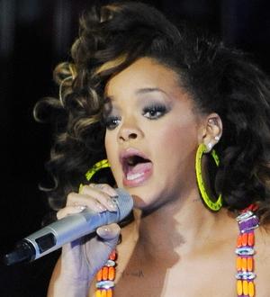 Rihanna strips for Armani ad
