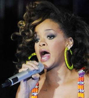 Rihanna strips for Armani ad