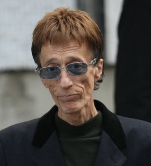 Gibb fights for life in coma