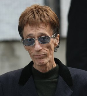 Gibb fights for life in coma