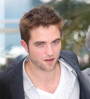 love bites for Robert Pattinson as removal men arrive at his house