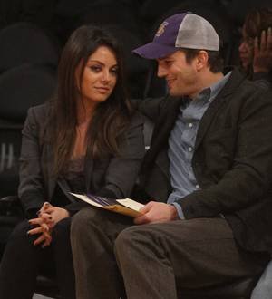 Mila Kunis and Ashton Kutcher poke fun at their romance on TV show