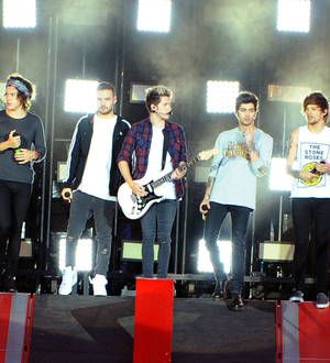 One Direction perform in torrential rain