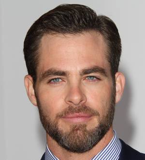 Chris Pine at the Venice Film Festival, dressed in a sleek suit and sunglasses, smiling for cameras