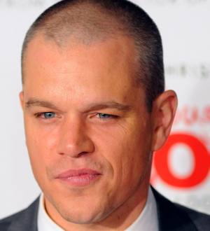 Matt Damon in a military uniform, holding a rifle and looking over his shoulder