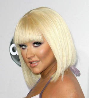 Jennifer Hudson in a black gown, Christina Aguilera in a white gown posing together at an event