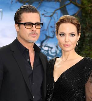 Brad Pitt and Angelina Jolie enjoy tea with British royals