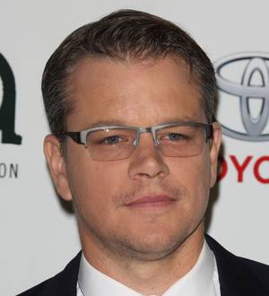 Matt Damon in an Italian coffee advertisement, looking serious in a black suit and white shirt