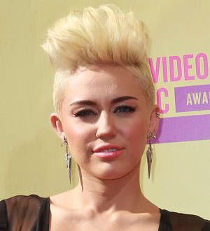 PETA bosses adopt pig as Miley Cyrus turns 20