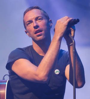 Chris Martin performs with Kings of Leon